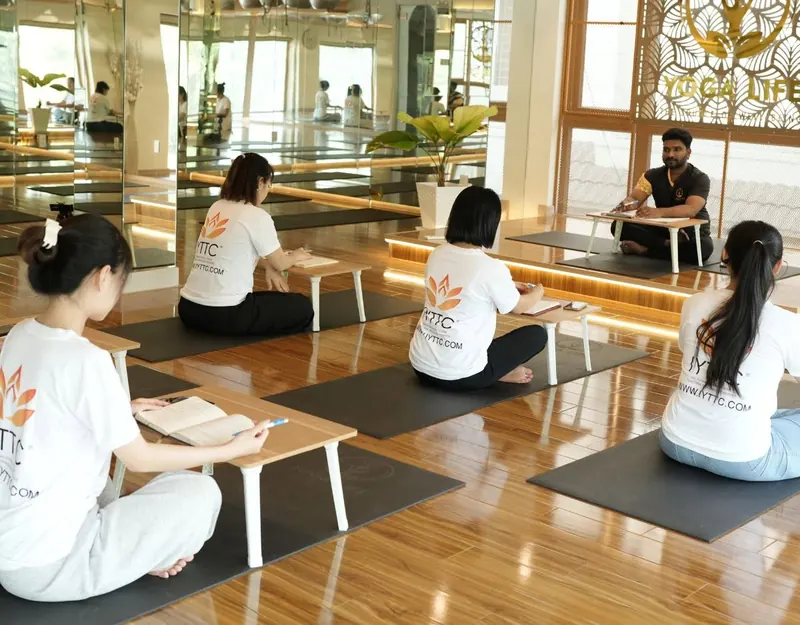 Teacher-training students practising together in the studio